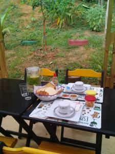 a black table with a plate of food on it at La Casa Rozada Prumirim in Ubatuba +82 photos