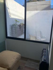 a room with a window with two toilets in it at Azul en Lavalle 3 in Azul