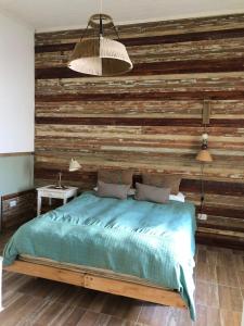 a bedroom with a wooden wall with a bed at Azul en Lavalle 3 in Azul