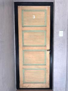 a wooden door in a room with a wall at Azul en Lavalle 3 in Azul