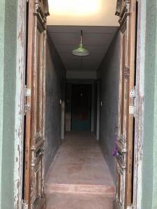 an empty hallway with an open door and a ceiling at Azul en Lavalle 3 in Azul +2 photos
