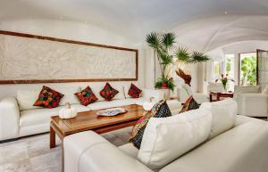 a living room with white couches and a table at Casa Jaguar in Puerto Aventuras +43 photos