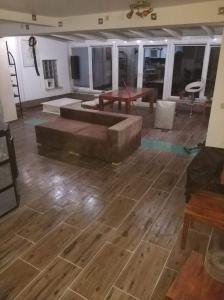 a living room with a couch and a wooden floor at WOHLFÜHLOASE - Zimmer, Appartment - im Herzen STARNBERGS in Starnberg