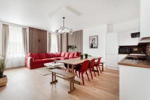 a living room with a red couch and a table at Luxury Two Bedroom Apartment in Marylebone - Central London in London