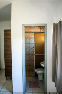 a bathroom with a toilet and a shower stall at Hotel Palugi in Joinville +39 photos
