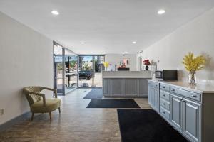 a kitchen with a counter and a chair in a room at Inn On Arsenal in Watertown