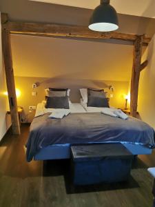a bedroom with a large bed with a blue comforter at LA CACHETTE ( de Kirrwiller ) in Kirrwiller