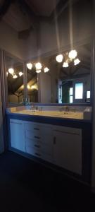 a bathroom with two sinks and a large mirror at FLOR AUSTRAL in Ushuaia