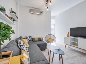 a living room with a couch and a table at Ático Puerto Fuengirola in Fuengirola