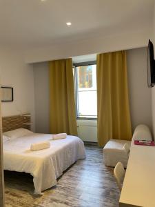 a bedroom with two beds and a large window at Moshi Moshi in Rome