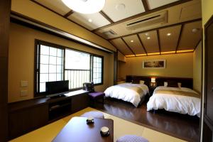 En eller flere senge i et værelse på Oyado Ikegami