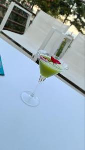 a drink in a martini glass on a table at Hatzoudis Luxury Suites in Chrysi Ammoudia