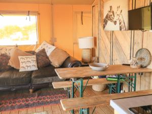 uma sala de estar com um sofá e uma mesa em Semira Tent Lodge em Totnes