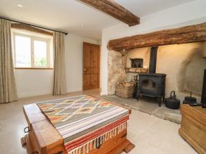 a bedroom with a bed and a wood stove at The Nook in Stroud