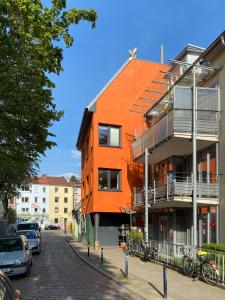 ein orangefarbenes Gebäude an der Straßenseite in der Unterkunft Super Host im Bremer Viertel. in Bremen