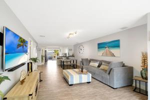 a living room with a couch and a table at Waterfront Fll&beaches, Bbq, Kayaks, Canoe in Dania Beach