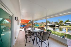 a dining room with a table and chairs on a patio at Waterfront Fll&beaches, Bbq, Kayaks, Canoe in Dania Beach