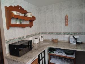 a kitchen with a counter with a stove top oven at Apartamentos Casa May II - Centro Benidorm in Benidorm