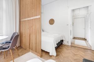 a bedroom with a bed and a wooden wall at WeHost Nordic Glamour nearby the Tervasaari Island in Helsinki