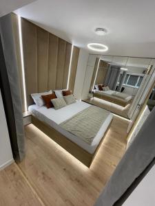 a bedroom with a large bed and a mirror at Palas Loft in Iaşi
