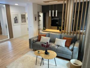 a living room with a couch and a table at Palas Loft in Iaşi +24 photos