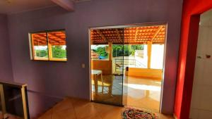 a living room with a door to a room with a table at Casa Santos - Pirenópolis in Pirenópolis
