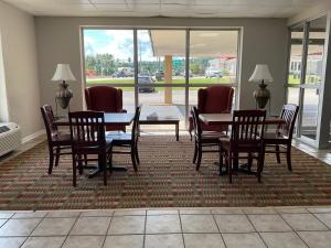 a dining room with a table and chairs on a rug at Days Inn by Wyndham Cambridge in Cambridge