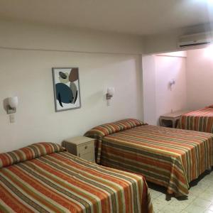 Postel nebo postele na pokoji v ubytování Hotel Lorena