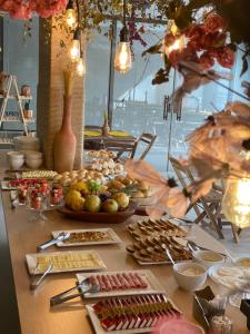 a table with a buffet of food on it at Porto de Galinhas PORTO EXCLUSIVE BY AFT in Porto De Galinhas