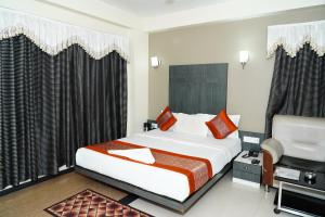 a hotel room with a bed and a sink at Marshall The Hotel in Ahmedabad