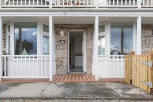 a front porch of a house with a wooden fence at Ocean Gate in Carbis Bay