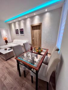 a living room with a table and chairs and a couch at Hugolina LUX in Belgrade