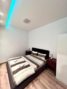 a bedroom with a large bed and two night stands at Hugolina LUX in Belgrade