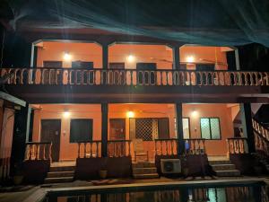 a house at night with a swimming pool at Cosmos @ Greenspace in Siolim