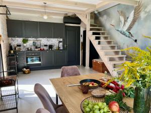 a kitchen with a table with a bird on the wall at Okno Na Wodę in Rybno