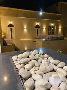a bunch of rocks on a grill in front of a building at Almouj Chalet in Salalah