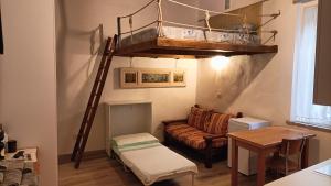 a living room with a loft bed and a couch at Etrusco in Chiusi