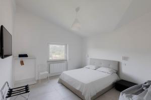 מיטה או מיטות בחדר ב-Claudio casa di Alba