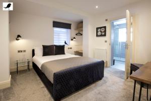 a bedroom with a king sized bed and a table at Blackbird Accommodation and Luxury Apartments room 12 in Blackpool