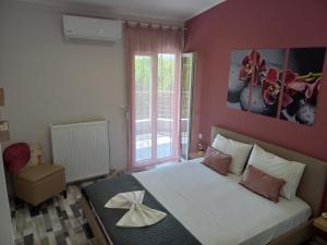 una camera da letto con un grande letto bianco e una finestra di V&L Sunset a Ioannina