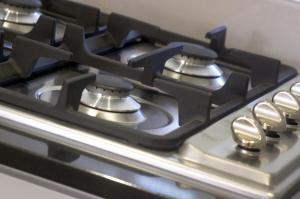 a stainless steel stove top oven sitting inside of a kitchen at L'Auberge @ Noosa in Noosa Heads