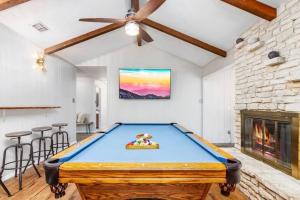 a pool table in a room with a fireplace at Salt Water Pool & Backyard Oasis @ Wild Eagle in San Antonio