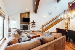 a large leather couch in a living room with a fireplace at Tyra Summit A3C in Breckenridge
