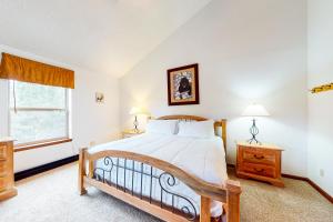 a bedroom with a large bed and a window at Tyra Summit A3C in Breckenridge +21 photos