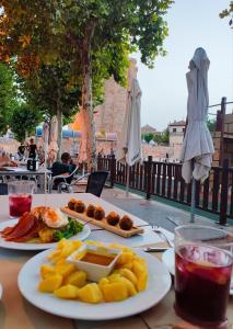 a table with two plates of food on it at Casa Luzon, terraza-solarium con ducha y salon rustico in Villarejo de Salvanés