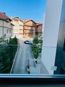 a view from a window of a street with buildings at Tower apartment in Pristina