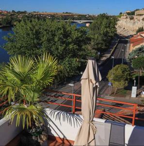 una sombrilla al lado de un balcón en A los Ojos del Río Duero en Zamora