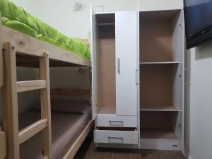 a room with two bunk beds and a tv at Habitación con baño privado Un piso por escalera in Buenos Aires