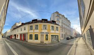 a yellow building on the side of a street at Appartement Pension 700m zum Ring in Vienna