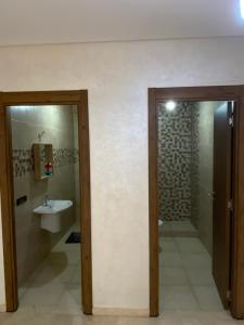 a bathroom with a sink and a toilet and a mirror at Best Appartement 3 BEDROOMS in Marrakech